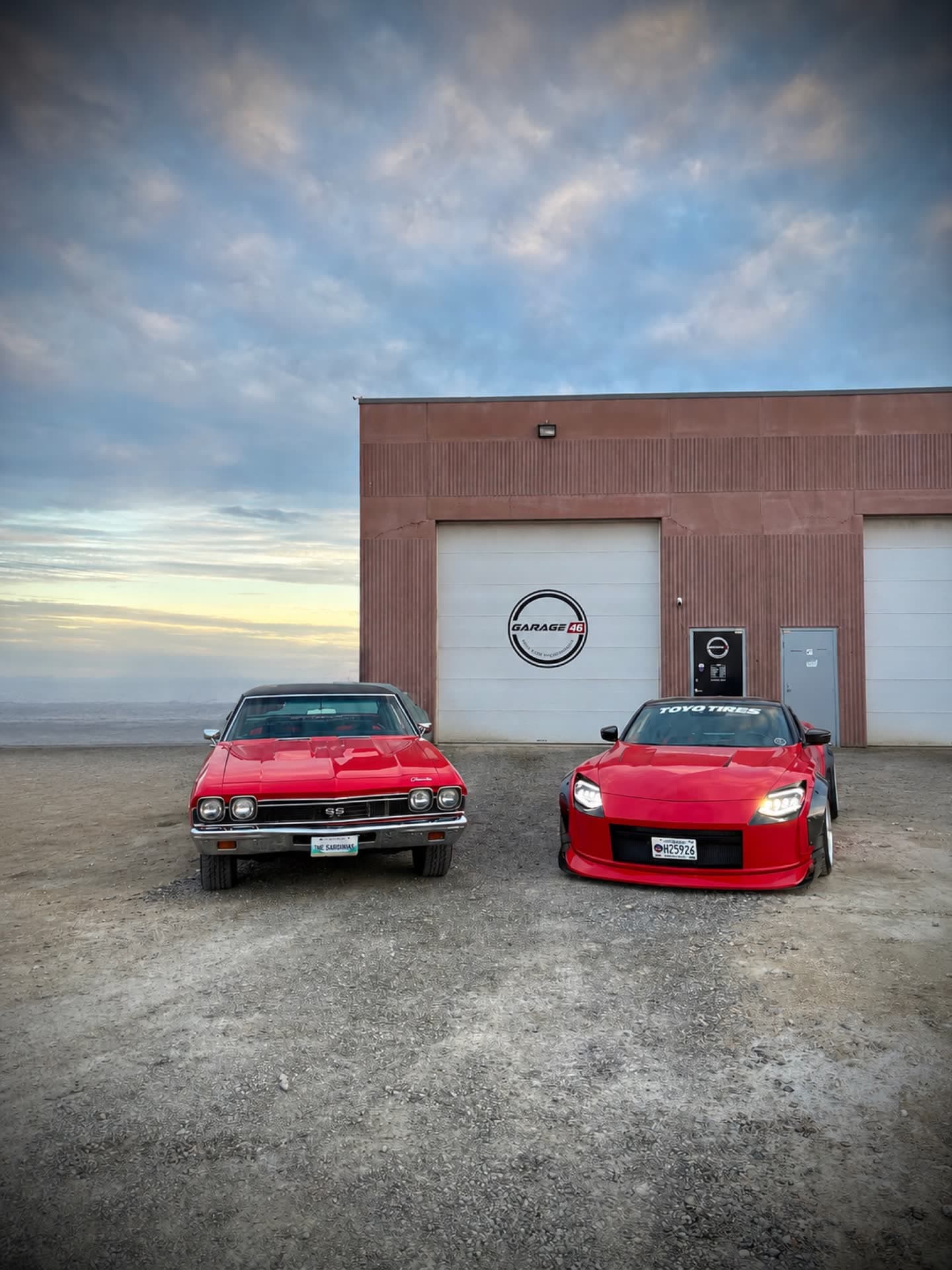 The Garage 46 Z beside a classic Chevelle outside the shop